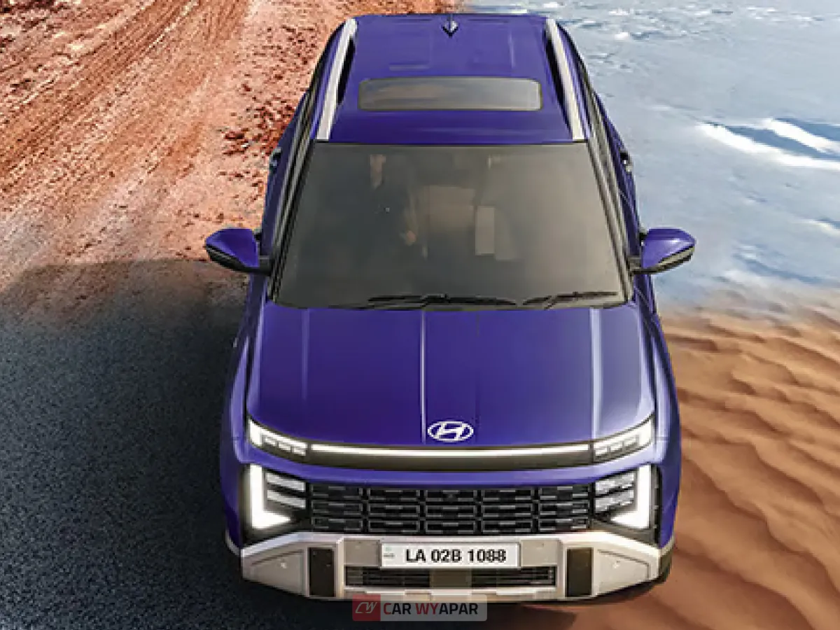 Front view of the 2025 Hyundai Venue in Titan Grey, showcasing the new dark chrome radiator grille, quad-beam LED headlamps, and L-shaped LED DRLs.